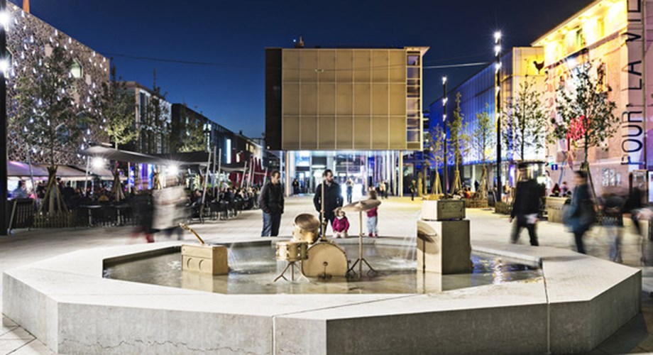 L'Esplanade, place centrale du Quartier du Flon avec sa fontaine et "Unplugged", oeuvre de Vincent Kohler, qui fait écho à l'univers musical très présent dans le quartier